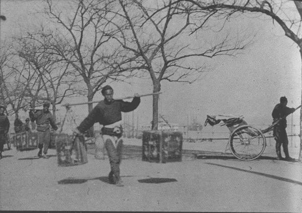 TEA FOR FOREIGN COUNTRIES  Coolies carrying tea packed for export; picture was taken in British concession of Hankow.