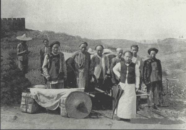 AUTHOR'S MODEST CARAVAN IN SZECH'UAN  And a fine body of men they were, kept in order by the general factotum in the foreground—each of them earning about 25 cents a day.