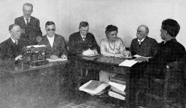 Miss Foley teaching a class of men at the Industrial Home for the Adult Blind, Oakland, California.