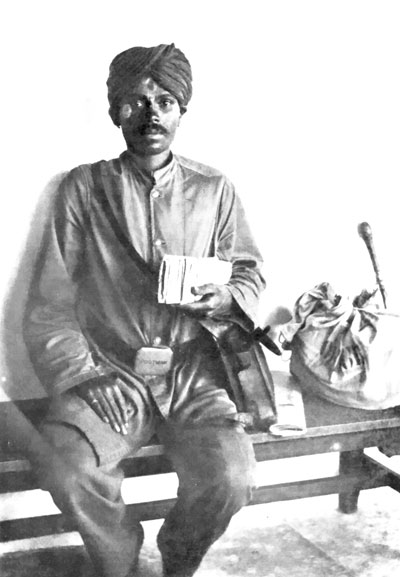 The Indian Village Postman.  (The white paint-marks on his forehead and cheeks indicate that Vishnu is his special god.)