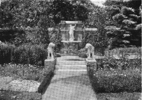 A FOUNTAIN THAT SERVES AS A BACKGROUND FOR A LILY POND