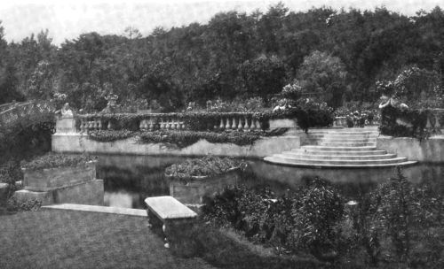 MARBLE STEPS LEADING TO THE WATER IN A FORMAL GARDEN