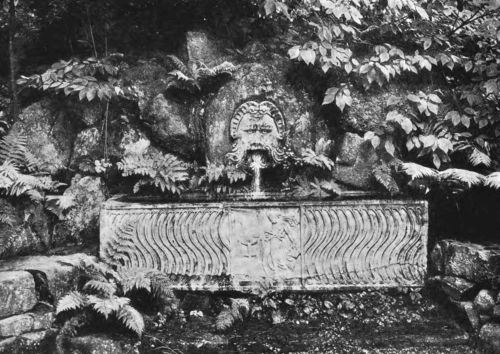 A ROMAN FOUNTAIN PLACED AGAINST A VERY APPROPRIATE BACKGROUND