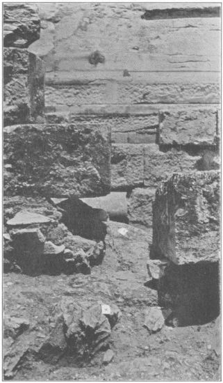 Figure 9  Looking north in the line of the eastern interior cross-wall. A view showing the orthostate which was in contact with the interior wall and the rough surface (X) of the native rock in the line of the latter