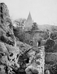 SHEIKH ADI. The upper end of the buildings showing the forecourt and entrance gateway: and (apparently) “the Proprietor,” seated on the wall above.