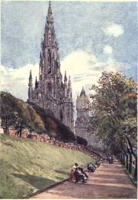 SIR WALTER SCOTT’S MONUMENT FROM THE EAST PRINCES ST. GARDENS  On the higher level above the green slope lies the part of the Gardens fronting Princes Street. The monument gains in height viewed from this lower level. The tower in the distance is that attached to the North British Railway Hotel.