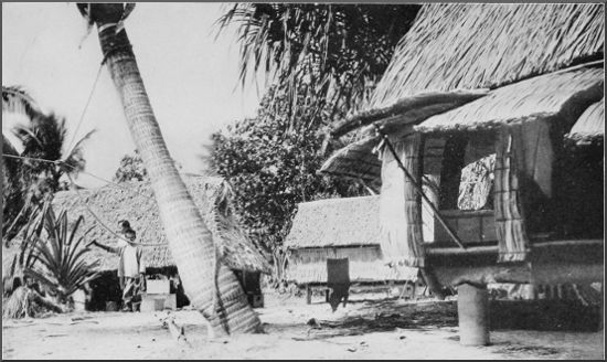 "Equator Town," showing corner of the sleeping-house and cook-house