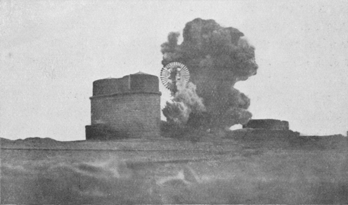 Photo wide shot of smoke from a blast at a building