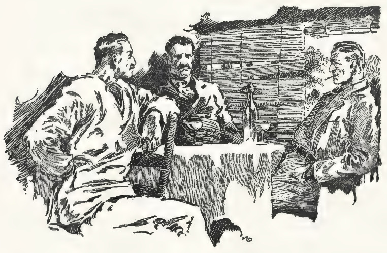 Three men sitting at a table