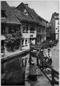 Copyright by Underwood & Underwood, N. Y.
STREET SCENE AT EISENBACH, SOUTHERN GERMANY
From the villages and small towns is recruited sixty per cent. of the German army.