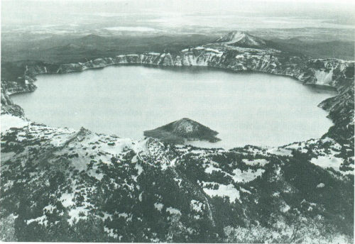 Crater Lake, Oregon; Wizard Island, a cinder cone, rises above the lake surface.